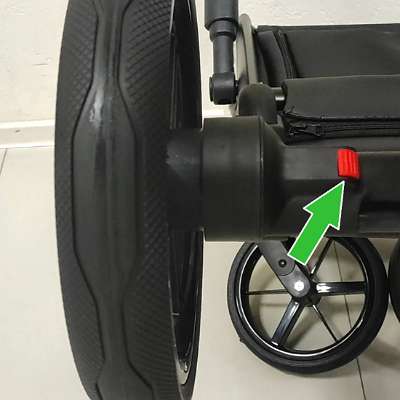 кнопка снятия заднего колеса коляски