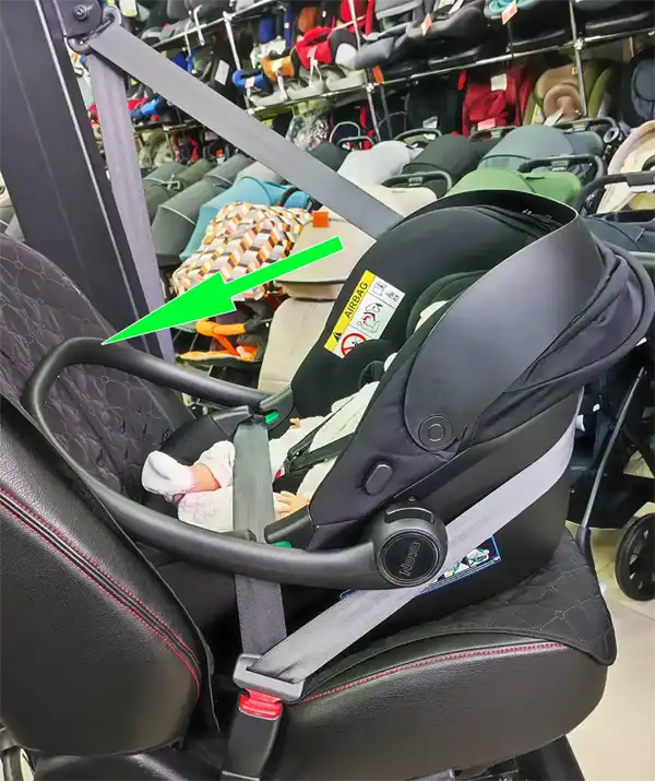 Correct position of the infant car seat handle acting as an anti-rebound bar against the vehicle seat
