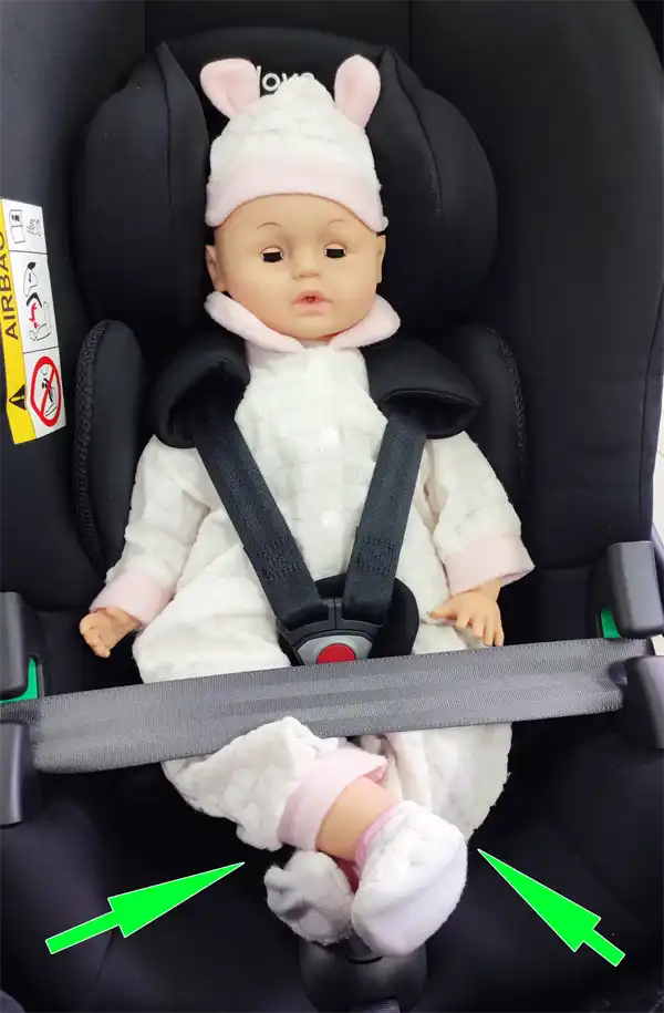 Mannequin in an infant car seat showing comfortable criss-cross leg position in a rear-facing setup