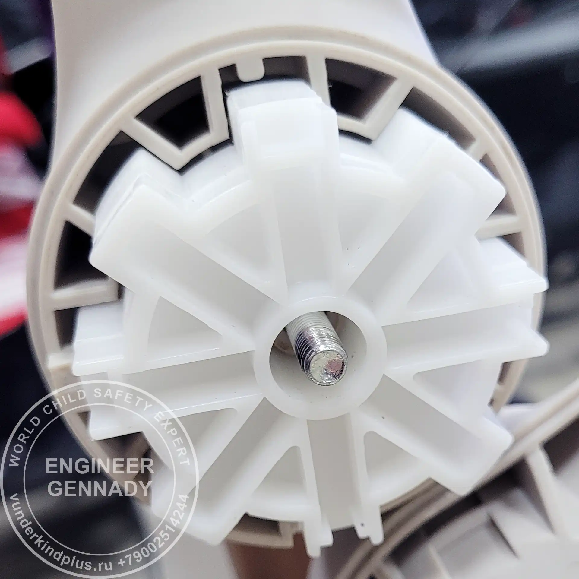 Macro shot of a large, well-crafted mechanical gear in a stroller mechanism.