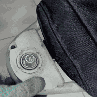 Engineer performing a tactile diagnostic test on a stroller bearing