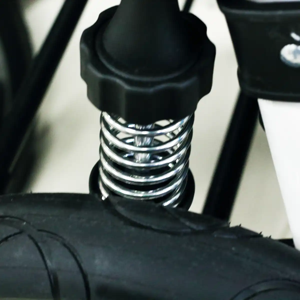 Internal mechanism of a direct coil spring shock absorber in a baby stroller