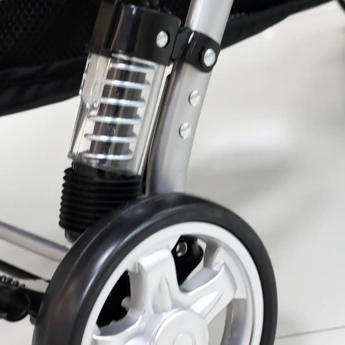 Example of decorative or cosmetic stroller suspension with zero to low mechanical spring travel